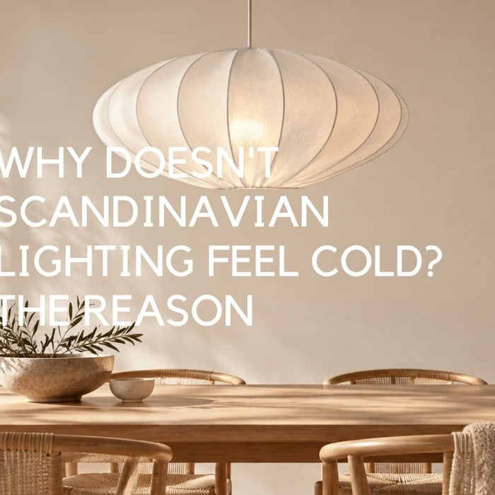 Scandinavian dining room with a softly glowing white pleated pendant light above a natural wood dining table, surrounded by woven chairs, neutral tones, ceramics and greenery. Lighting.co.za