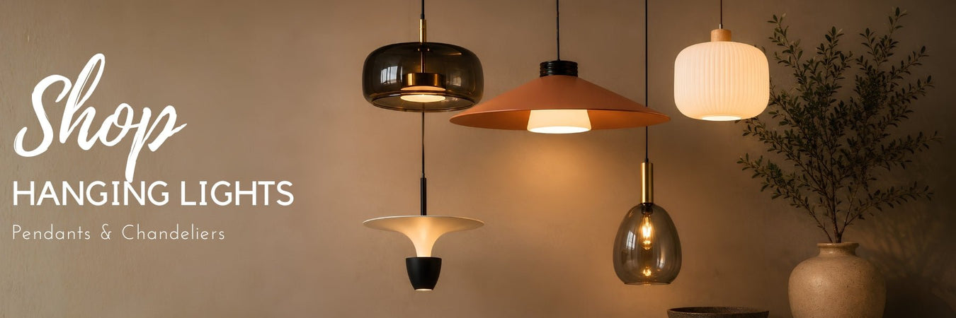 Statement pendant lights and a chandelier hanging above a dining table