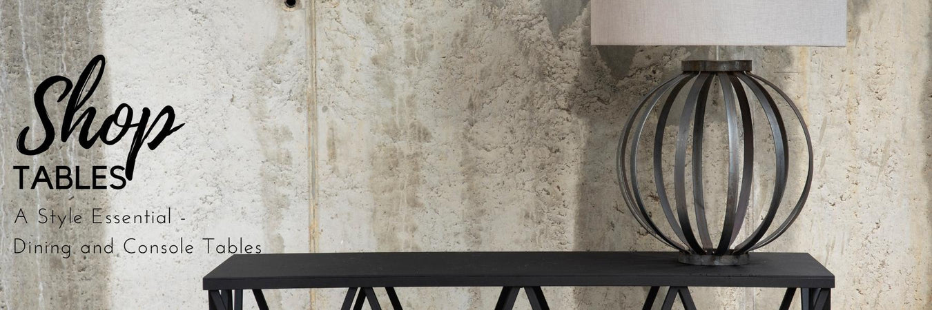 Console table styled with a lamp and artwork in an entryway
