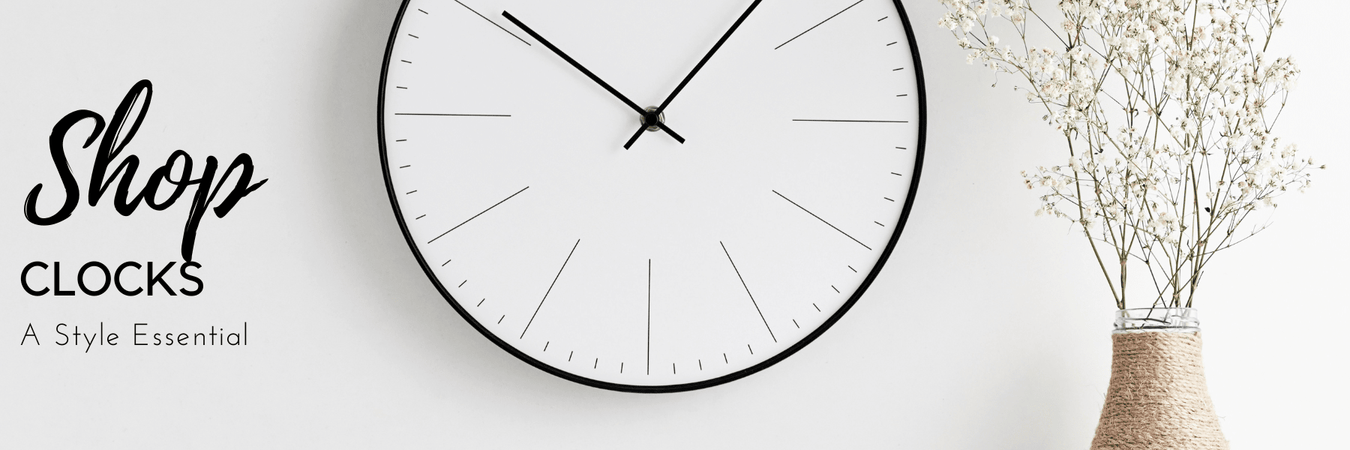 Wall clock styled above a console table in a modern hallway