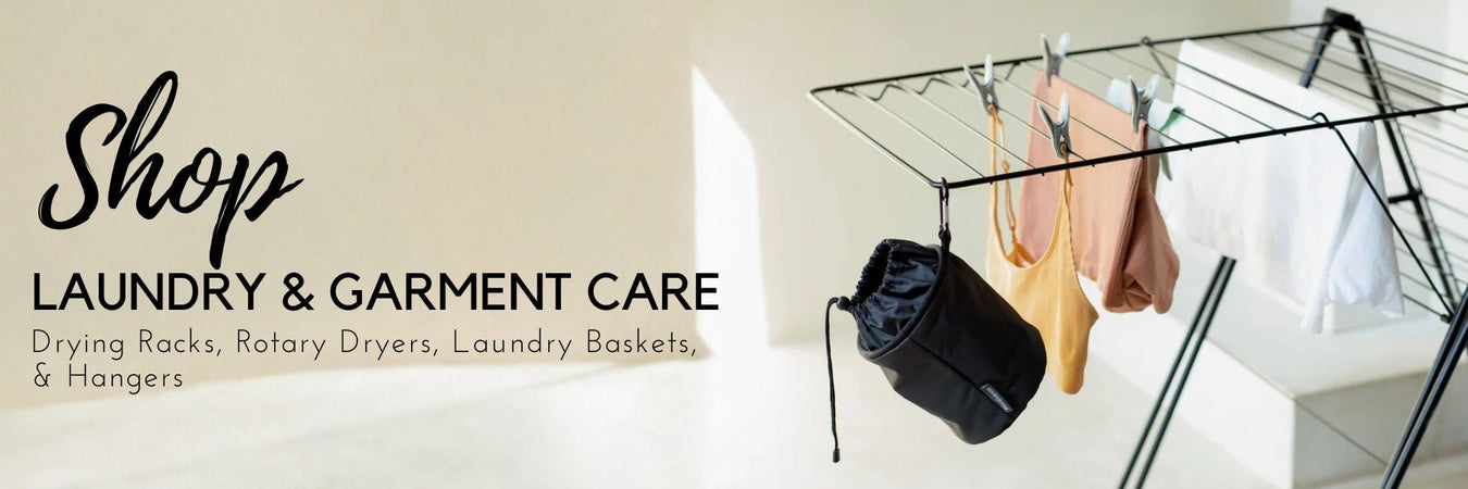 Drying rack and laundry basket styled in a bright laundry room
