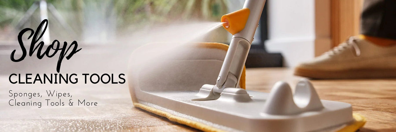 Cleaning sponges, cloths and spray bottles arranged on a countertop
