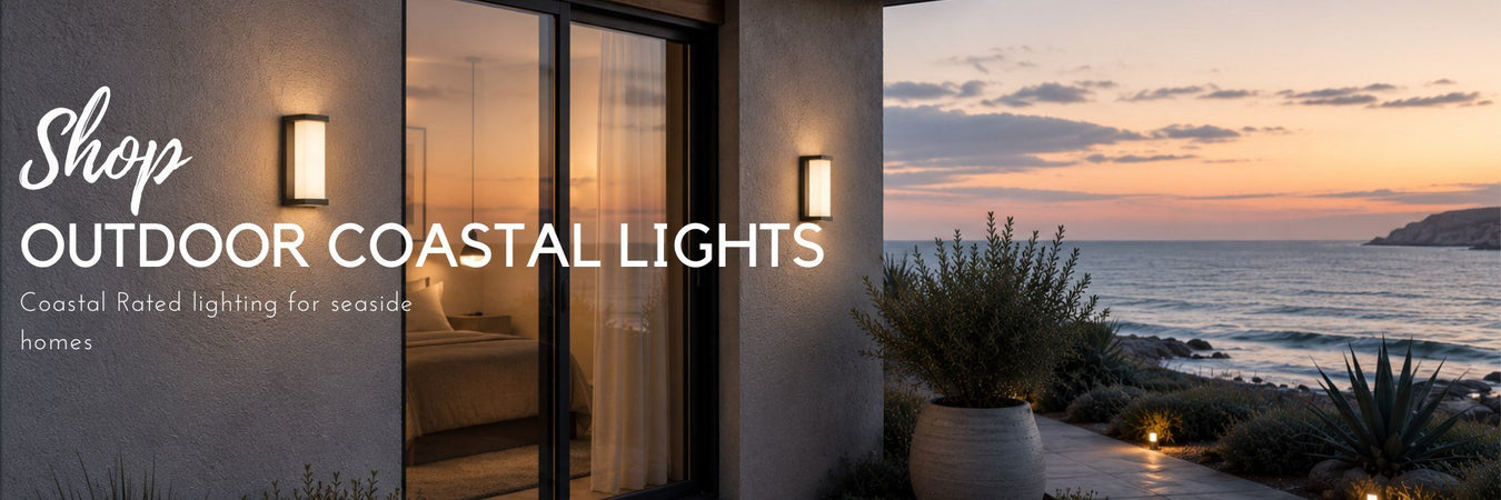 Stainless steel coastal-rated wall light on a seaside home exterior