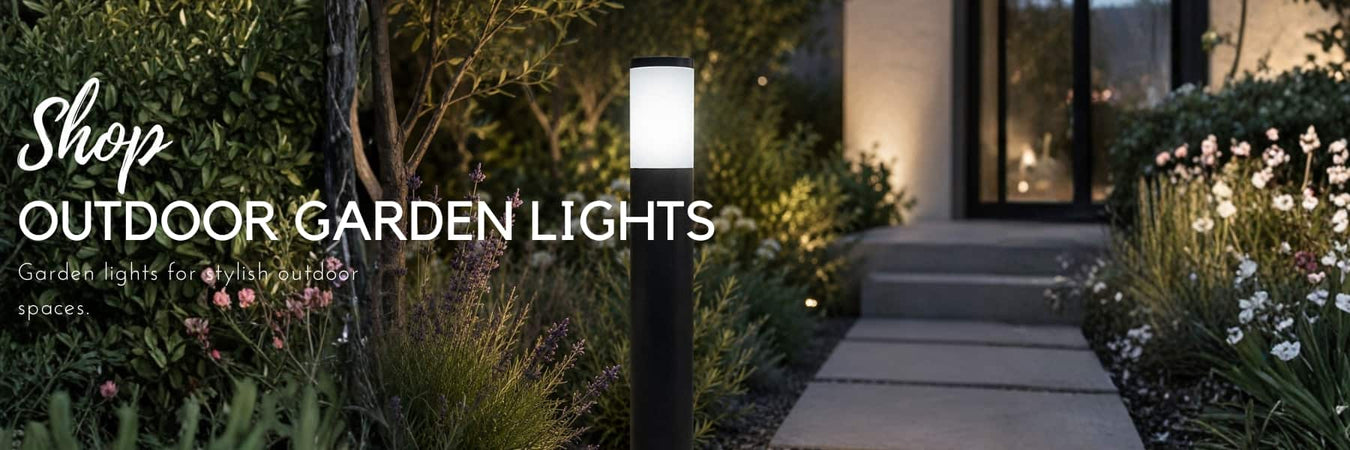 Modern black outdoor bollard light illuminating a landscaped garden pathway leading to a contemporary home at dusk – Lighting.co.za
