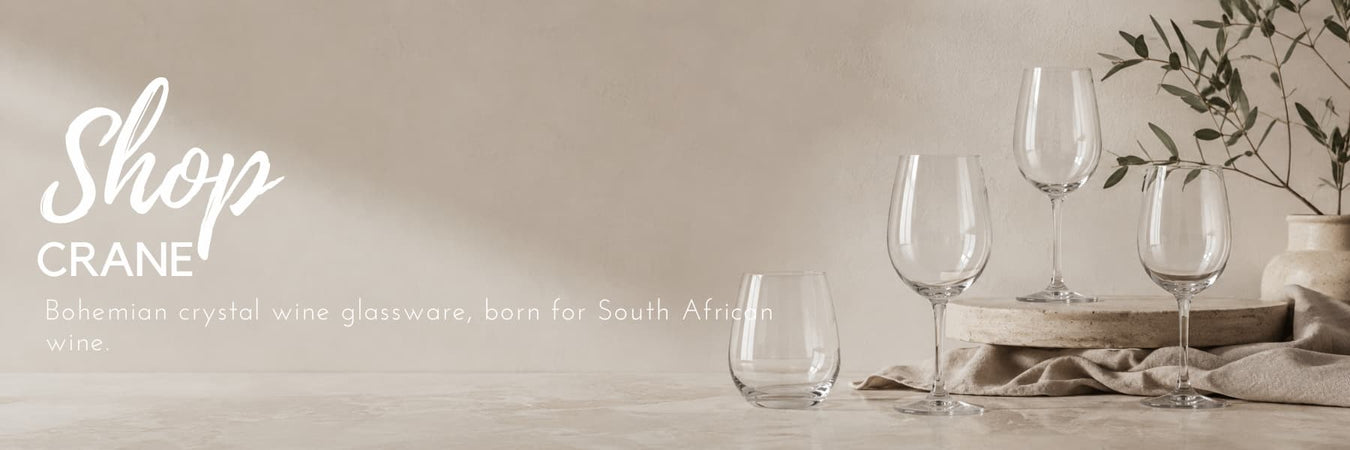 Crane crystal wine glassware styled in a soft neutral setting with elegant stemware and natural textures. Premium glassware designed for South African wine lovers and modern entertaining.