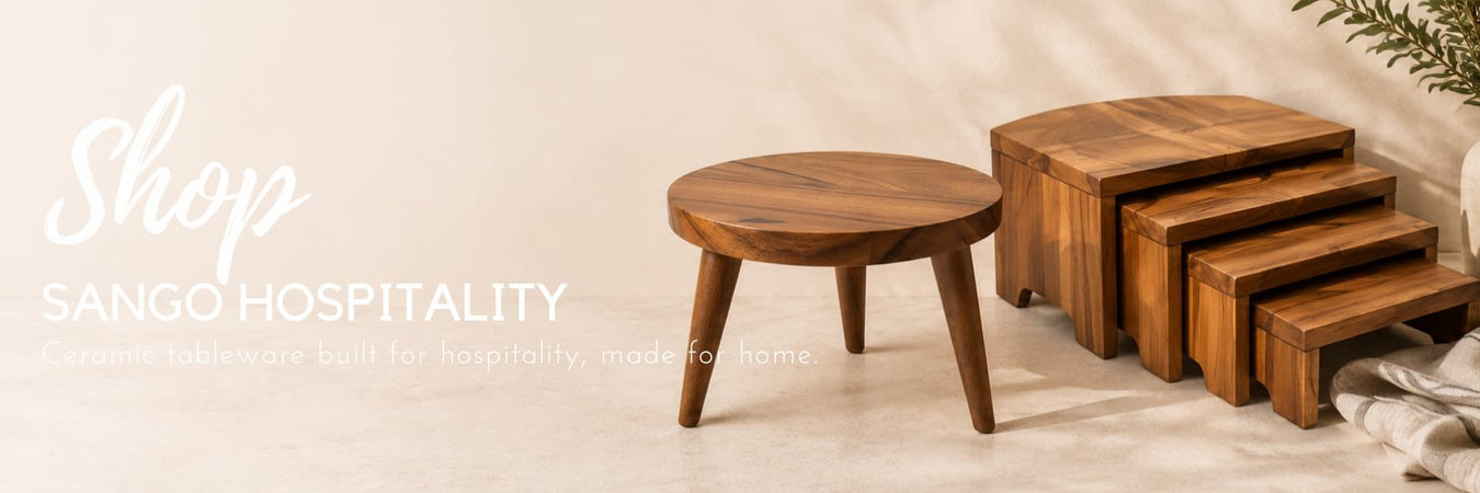 Sango Hospitality wooden serving stands and display risers, styled in a warm neutral setting. Hospitality-inspired tableware accessories designed for both commercial and home entertaining.