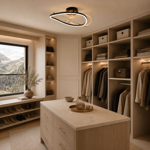 A modern walk-in closet with built-in shelving, hanging garments, storage boxes, a light wood island, and a large window overlooking mountains. A gold and black CCT LED ceiling light is mounted on the ceiling - Lighting.co.za