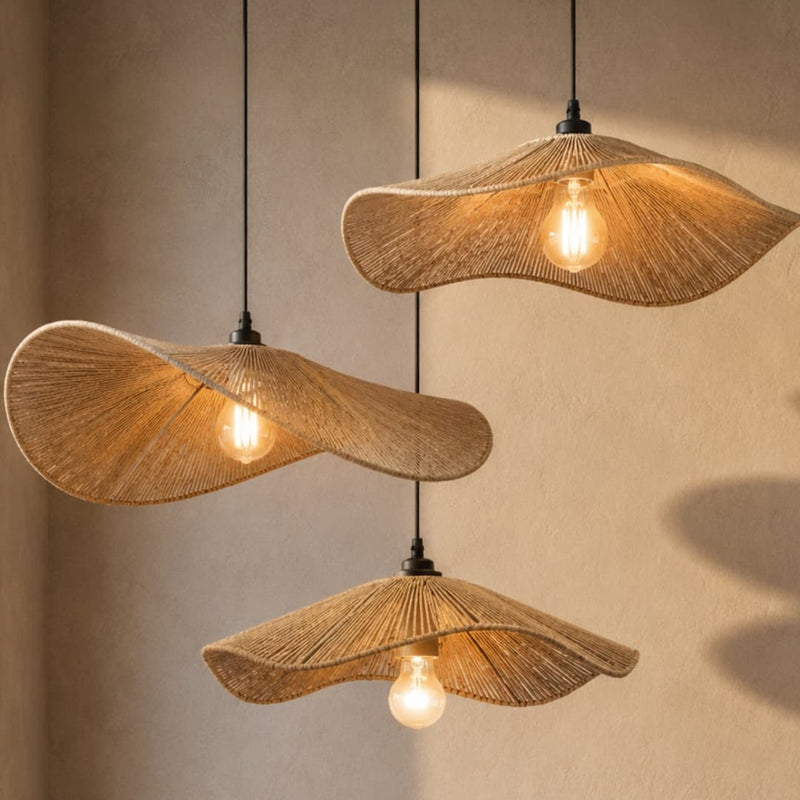 Three woven pendant lights hanging against a neutral wall.