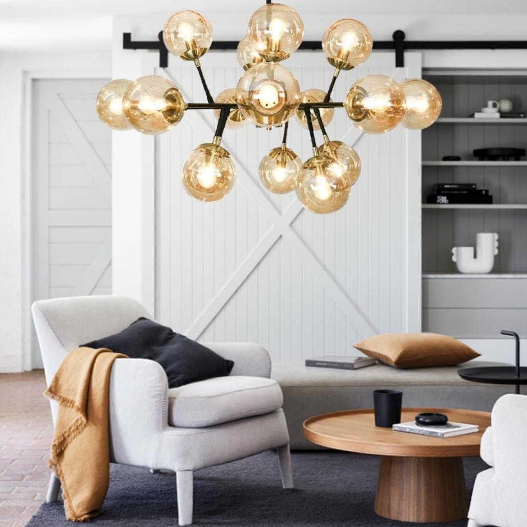 Modern amber glass globe chandelier in a contemporary living room with warm neutral décor – Lighting.co.za