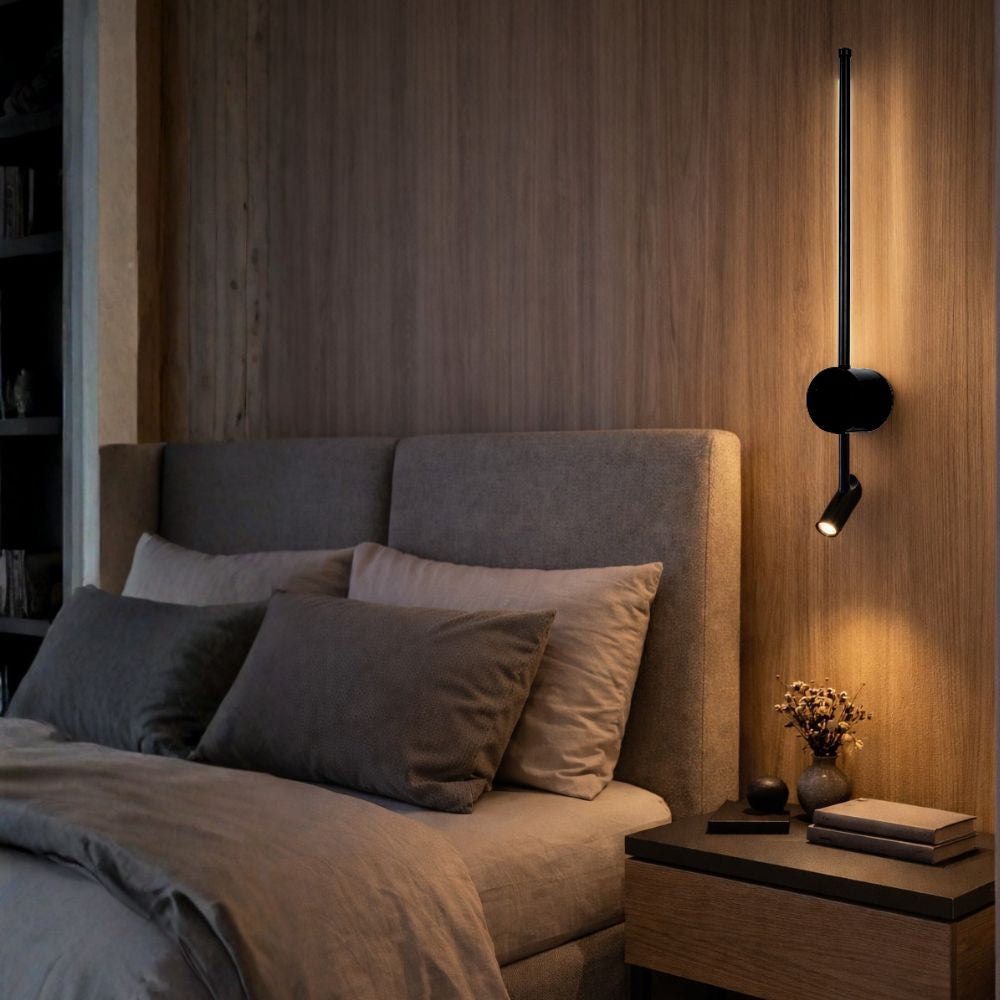 Modern bedroom with a bed, nightstand, and wall-mounted lamp.