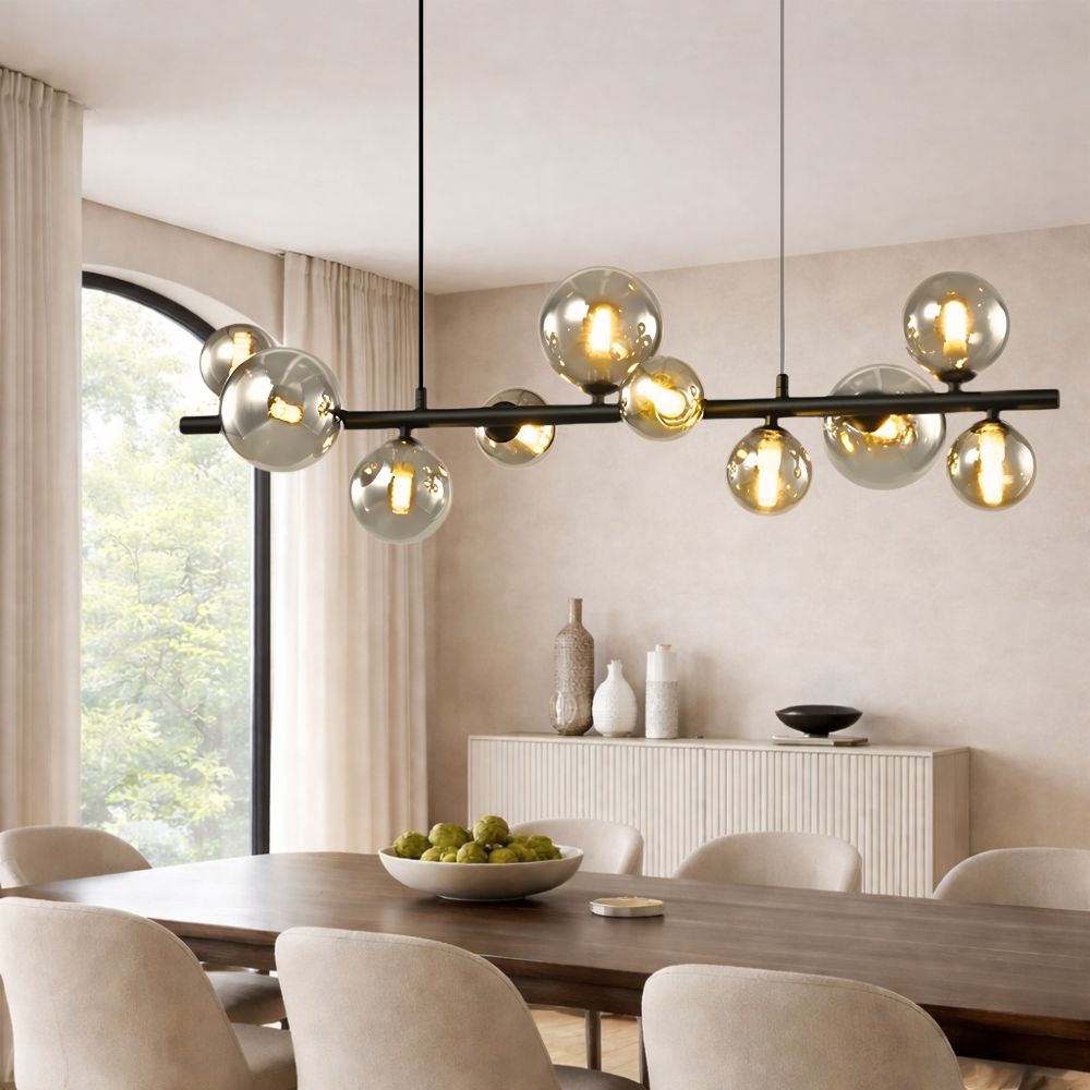Modern chandelier hanging above a dining table in a well-lit room with neutral decor.