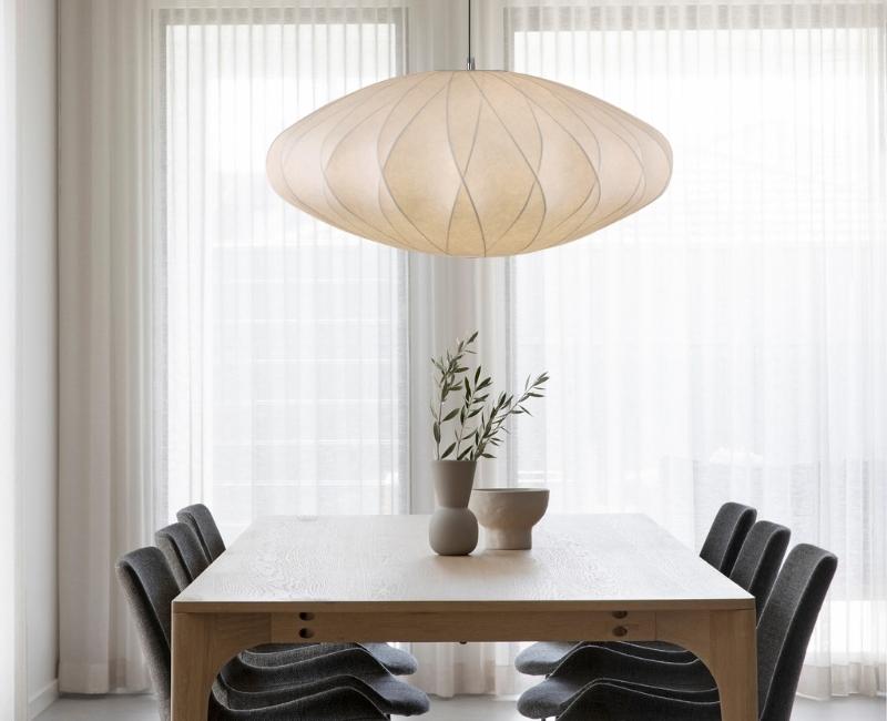 White fabric pendant light above a light wood dining table in a modern Japandi dining room – Lighting.co.za
