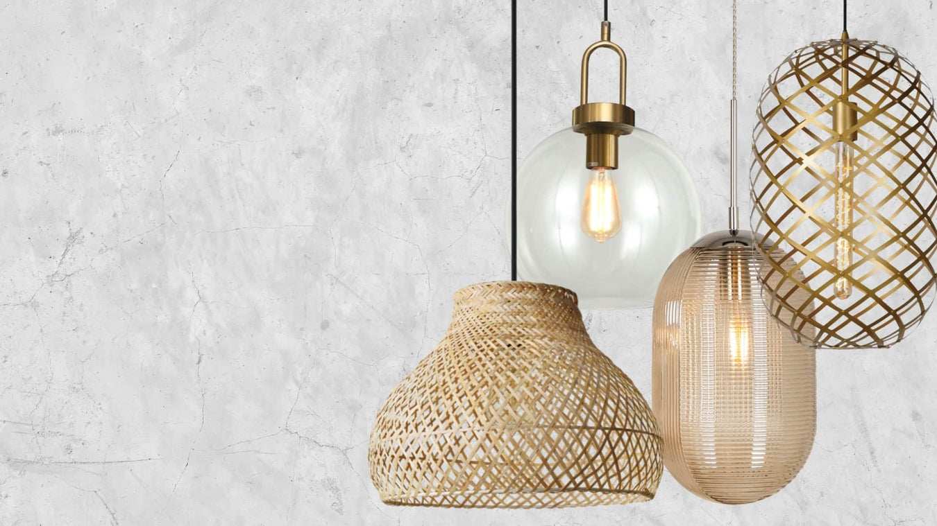 Cluster of Rattan, Glass and Gold Metal Pendants by a textured cement wall - Lighting.co.za