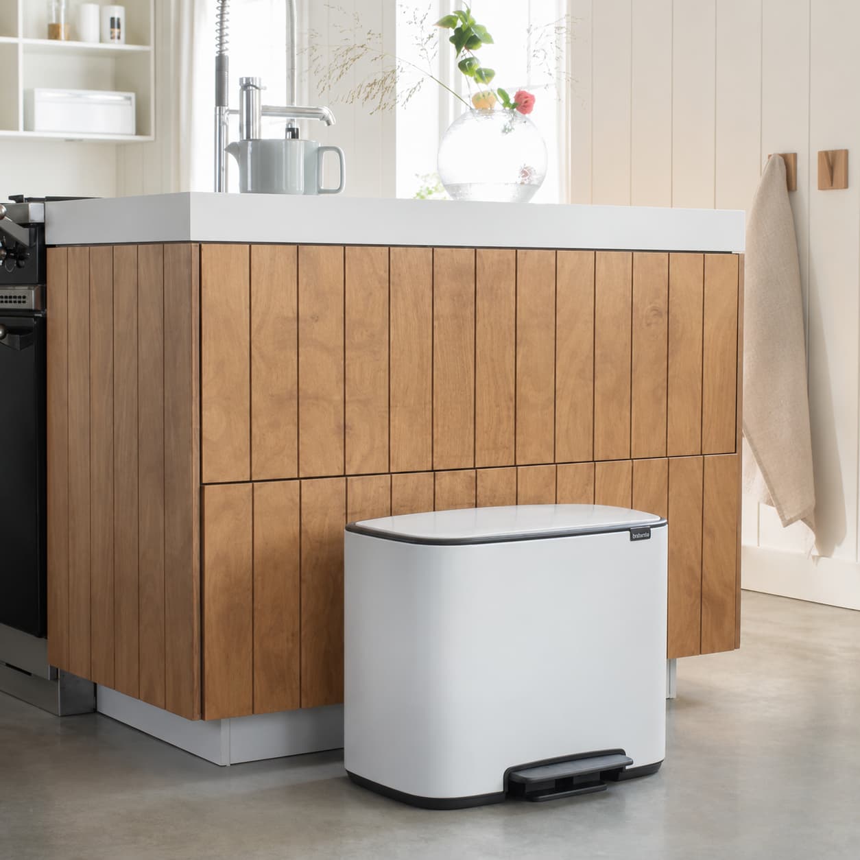 Organised laundry basket, bathroom caddy and cleaning supplies in a tidy home